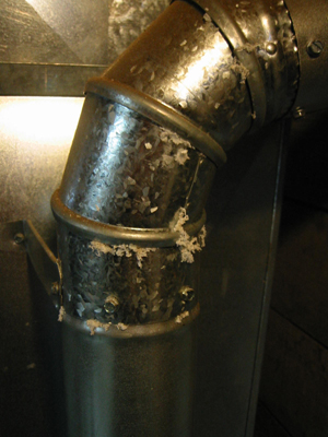 Furnace exhaust pipe with white material